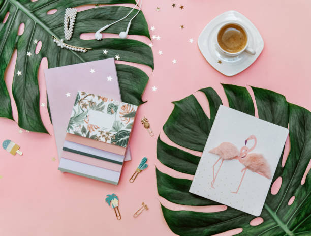 istock Flat lay woman Pink tropical office desk table with notebook, computer keyboard and other office supplies. Creative blogger concept 1301085015