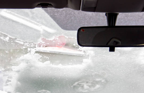istock Cleaning car after snow storm 1301086036