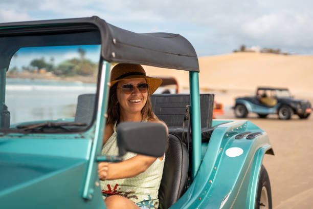 istock Tourist driving buggy on Genipabu beach 1301086375
