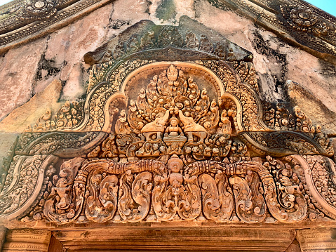 Banteay Srei, Cambodia - January 21, 2020: Banteay Srei is a 10th-century Cambodian temple dedicated to the Hindu god Shiva. It is built largely of red sandstone that can be carved like wood and millions of visitors admire the intricate reliefs carved in red colored sandstone.