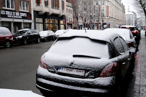 Cars covered with fresh white snow in Brussels, Belgium on February 7th, 2021.