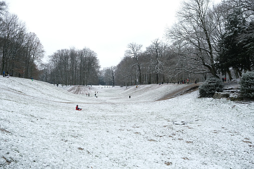 Kids enjoying the snow in Bois de la Cambre park  in Brussels, Belgium on February 7th, 2021.