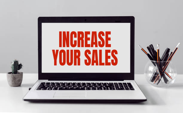 istock Open laptop on old white desk with text INCREASE YOUR SALES 1301088427