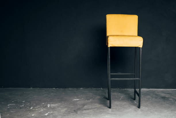 istock Elegant yellow bar chair in an empty room 1301088432