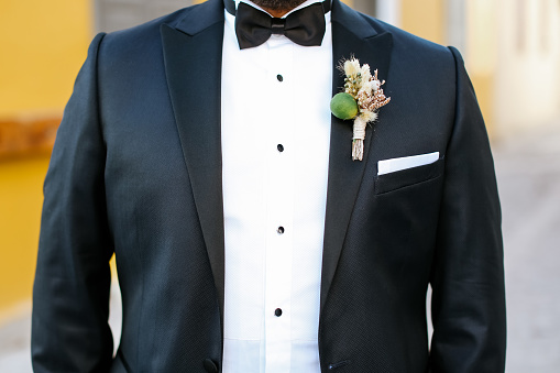 A groom preparing to marry the love of his life. Close up of businessman wearing cufflinks. Elegant young fashion business man wearing suit
