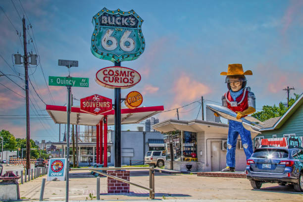 urio and souvenir shop along route 66 in tulsa oklahoma featuring statue of space cowboy holding rocket created from retro gas station. - route 66 thoroughfare sign number 66 imagens e fotografias de stock