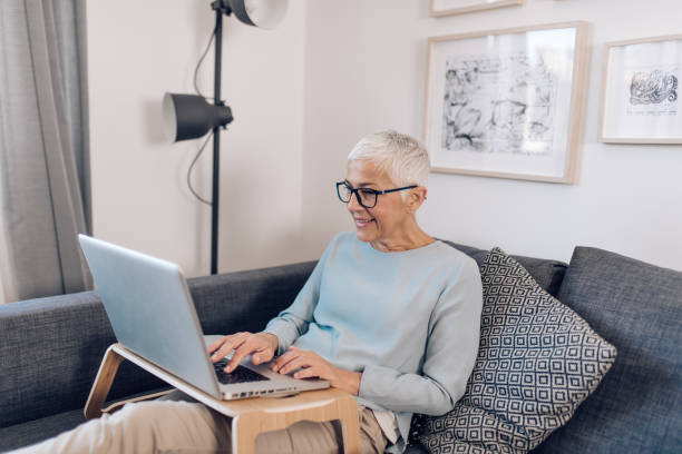 istock Mature entrepreneur working from her cozy sofa 1301091276