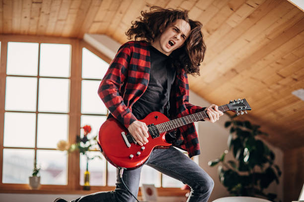 istock Male guitarist having fun playing electric guitar 1301092424