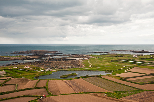 Aerial view on the sea and the village of Batz island, at the top of the lighthouse. Brittany in France.