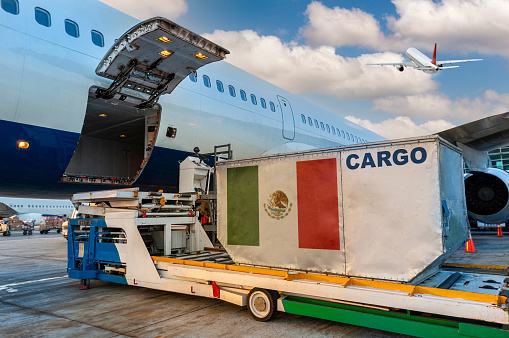 Loading the container with a Mexican flag in the cargo airplane.