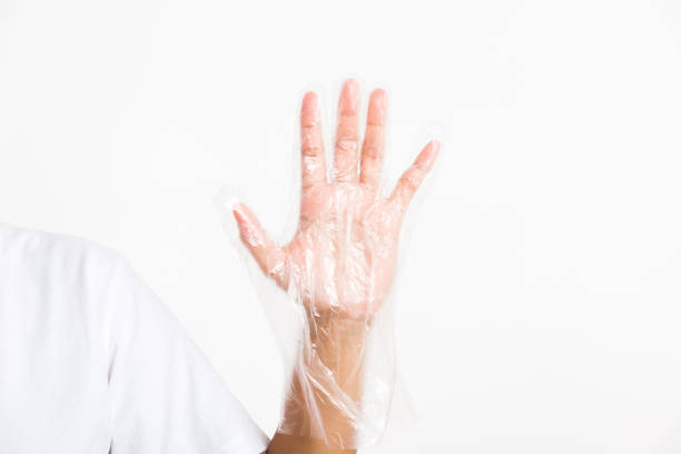 istock Woman hand wearing single use protect disposable transparent plastic glove 1301102260