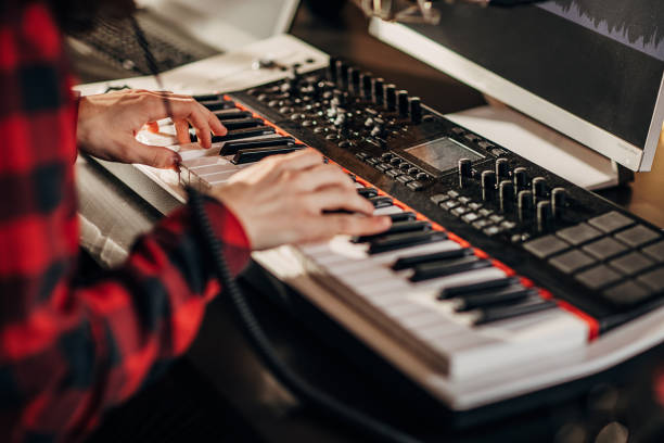 istock Male artist playing keyboard in recording studio 1301103922