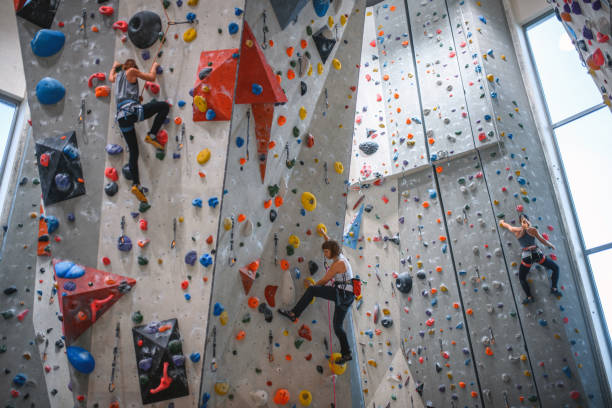 istock Three Female Athletes Working Out on Sport Climbing Walls 1301107402