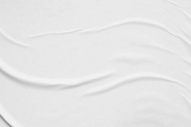 istock Blank white crumpled and creased paper poster texture background 1301107409
