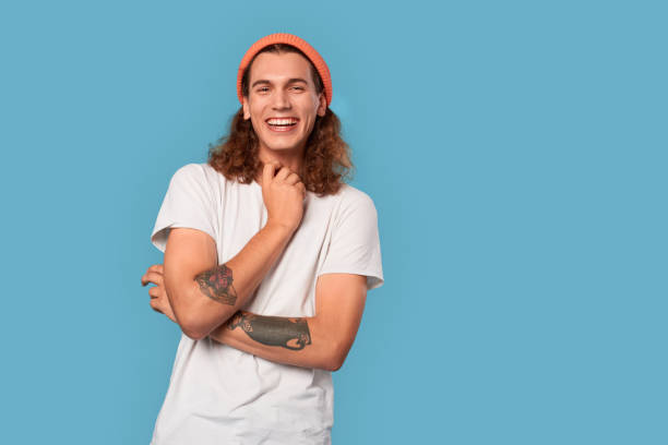 istock Young adult guy laughing and looking at camera 1301107670