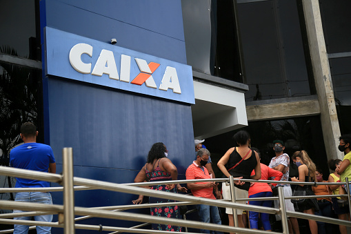 salvador, bahia, brazil - february 5, 2021: people are seen at the front door of a branch of Caixa Economica Federal bank in the Rio Vermelho neighborhood in the city of Salvador.