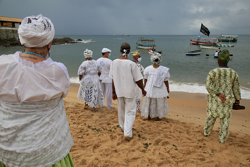salvador, bahia, brazil - february 2, 2021: members of the Candomble religion are seen during an offering delivery to the orisha Yemanja on the Rio Vermelho beach in the city of Salvador.