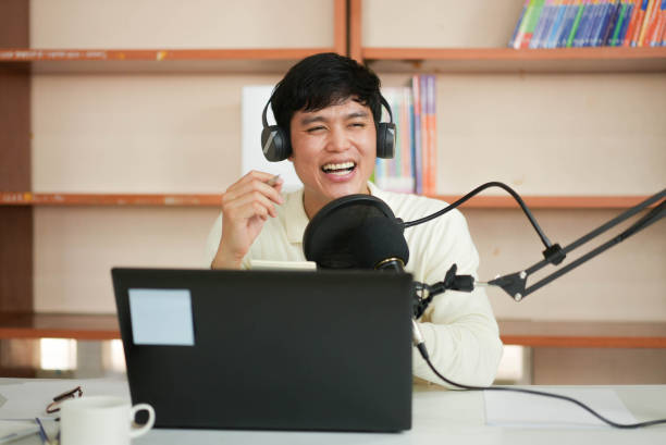 istock close up young asian man with headset talking on microphone to start explain and share about news or inspired content to motivation audience at home office for millennial lifestyle concept 1301109917