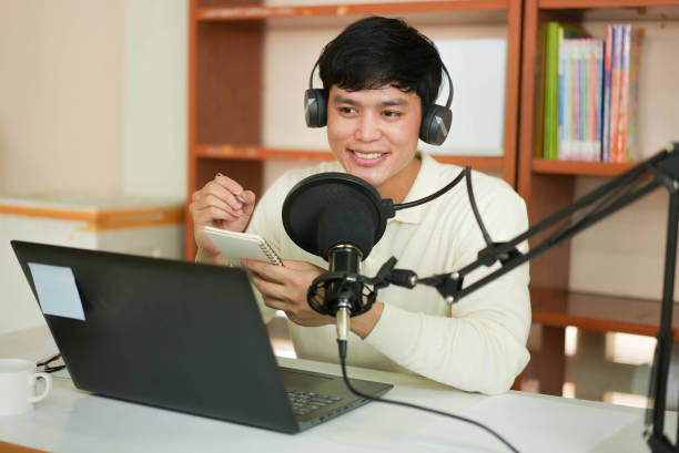 istock close up young asian man with headset talking on microphone to start explain and share about news or inspired content to motivation audience at home office for millennial lifestyle concept 1301109918