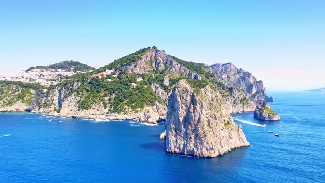 Orbiting shot of the three famous rocks off the Capri island, world-renowned