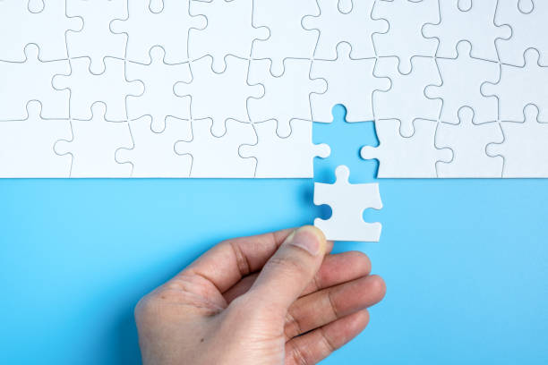 istock Hand complete the last piece white puzzle for business concept 1301111294