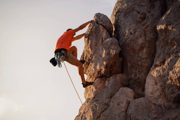 istock Low angle view of a young climber on the rocky mountain 1301111998