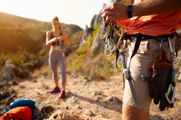 istock An unrecognizable man preparing carbines on a safety harness for climbing 1301112011