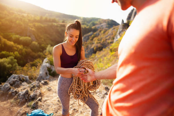 istock Smiling young woman holding climbing rope 1301112019