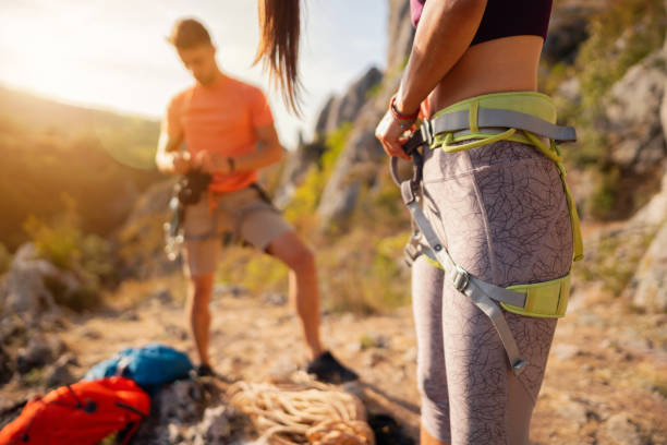 istock An unrecognizable woman preparing her safety harness for climbing 1301112025