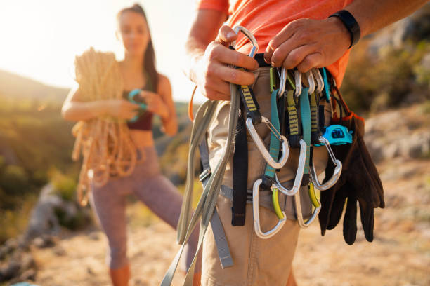istock An unrecognizable man putting carbines on a safety harness, preparing for climbing 1301112027