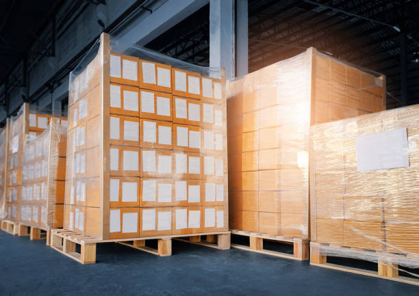 istock Stacked of cardboard boxes wrapped plastic film on pallet rack. shipment boxes. cargo export. warehouse storage. 1301112956