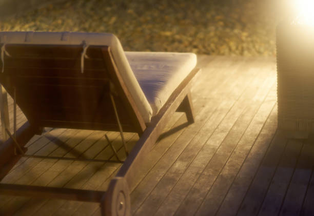 Two matching wood chairs on deck overlooking ocean.