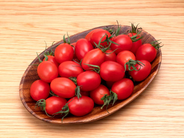 Cherry tomato named Aiko Cherry tomato named Aiko grape tomato stock pictures, royalty-free photos & images