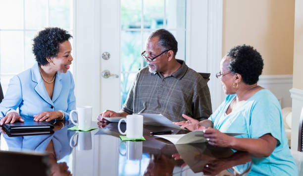istock Senior couple at home with financial advisor 1301117731