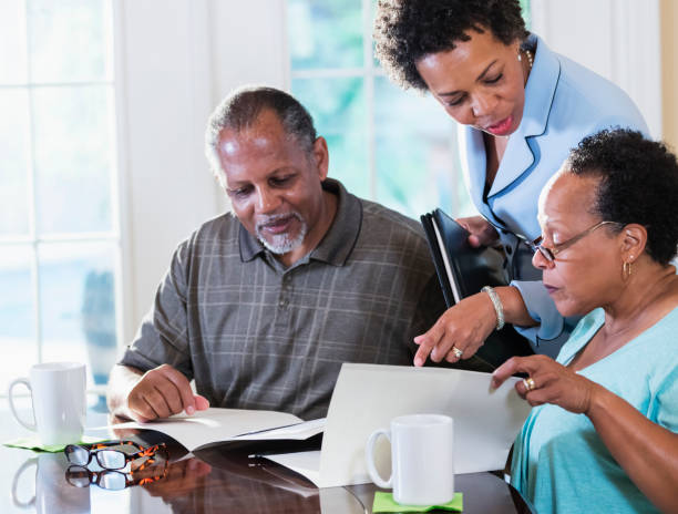 istock Senior couple at home with financial advisor 1301117738