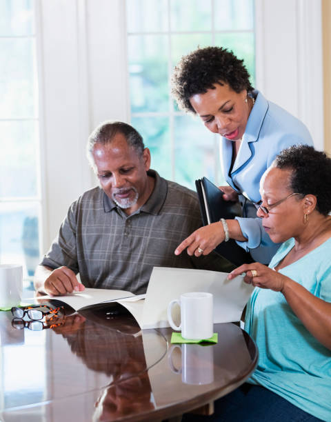 istock Senior couple at home with financial advisor 1301117746
