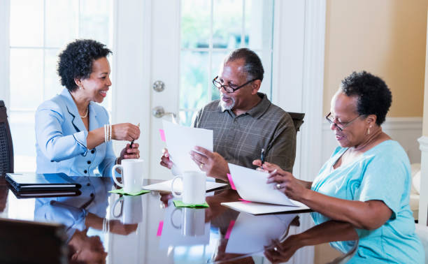 istock Senior couple at home with financial advisor 1301117751