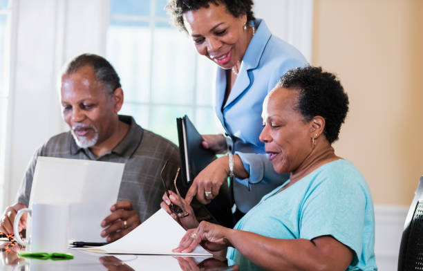 istock Senior couple at home with financial advisor 1301117752