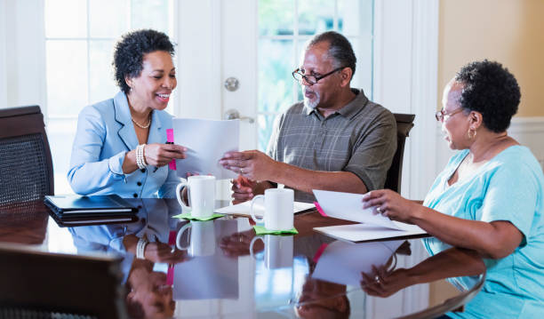 istock Senior couple at home with financial advisor 1301117763