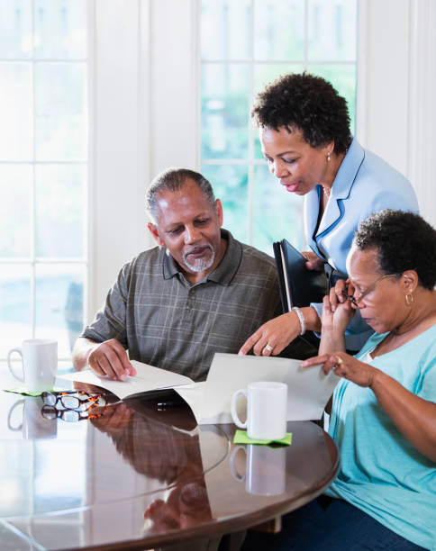istock Senior couple at home with financial advisor 1301117764