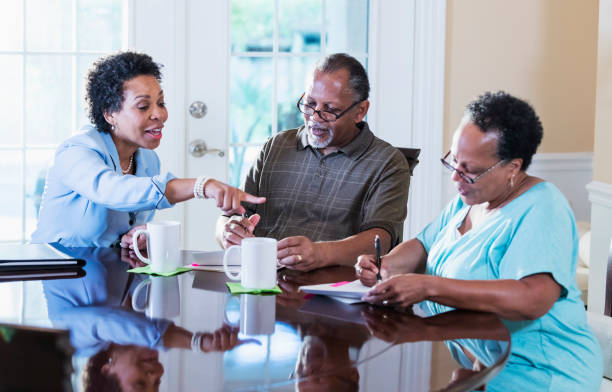 istock Senior couple at home with financial advisor 1301117780
