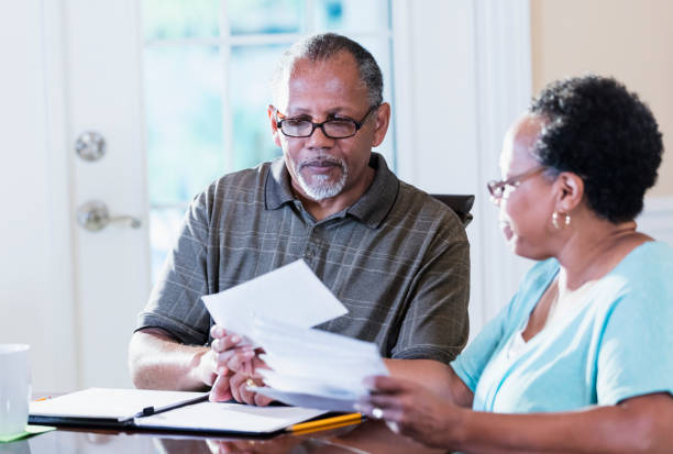 istock Senior couple at home paying bills 1301117786