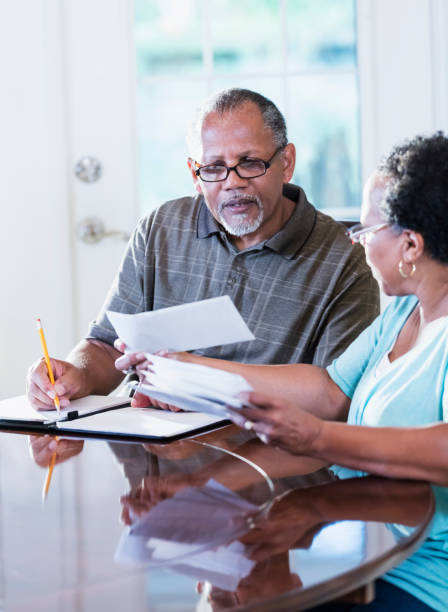 istock Senior couple at home paying bills 1301117792