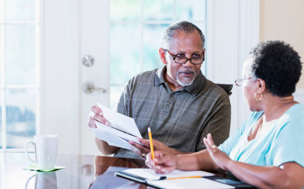 istock Senior couple at home paying bills 1301117805