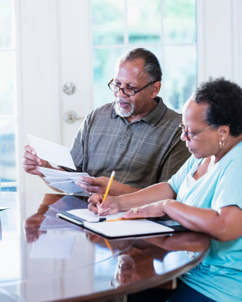 istock Senior couple at home paying bills 1301117807