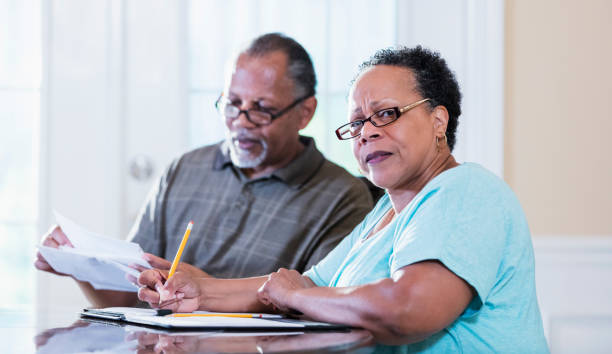 istock Senior couple at home paying bills 1301117809