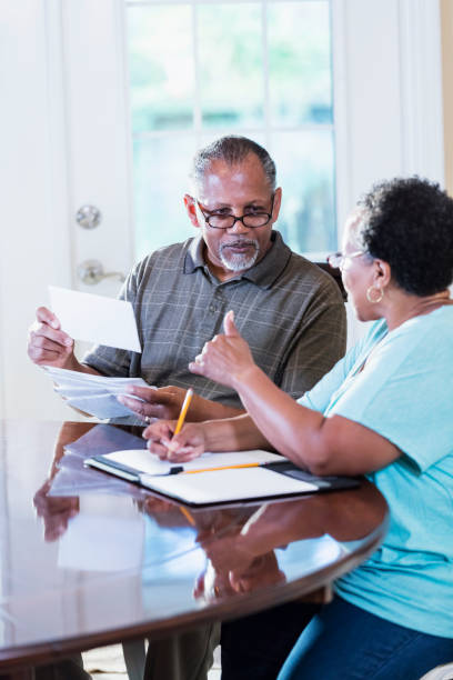 istock Senior couple at home paying bills 1301117814