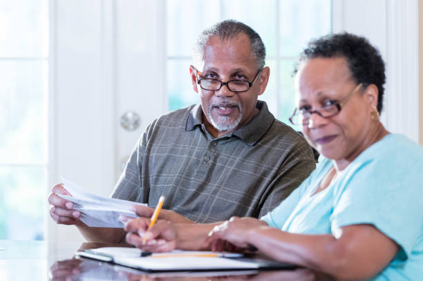 istock Senior couple at home paying bills 1301117816