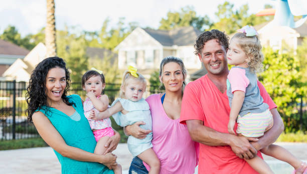 istock Family and friends with three young daughters 1301117826