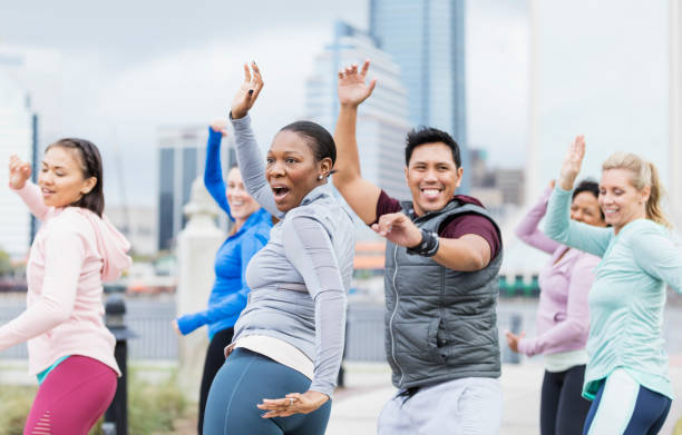 istock African-American woman leading group exercise class 1301118410